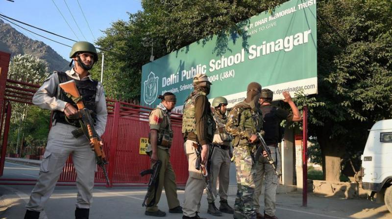 Special task force of police positioned outside a school during search operation after the CRPF vehicle was attacked by militants at Pantha Chowk in Srinagar. (Photo: PTI)