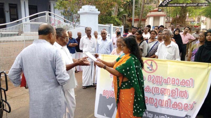 Residents hand over a memorandum to Mahe MLA Dr Ramachandran after taking out a protest march against the liquor mafias move to open outlets and bars in residential areas.