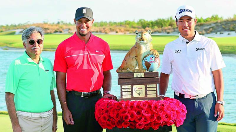 Hideki Matsuyama (right) poses with the trophy alongside Tiger Woods at Albany Course in the Bahamas on Sunday.