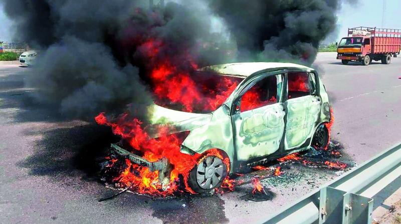 The car that caught fire on Sultanpur on the Outer Ring Road (ORR) on Wednesday.