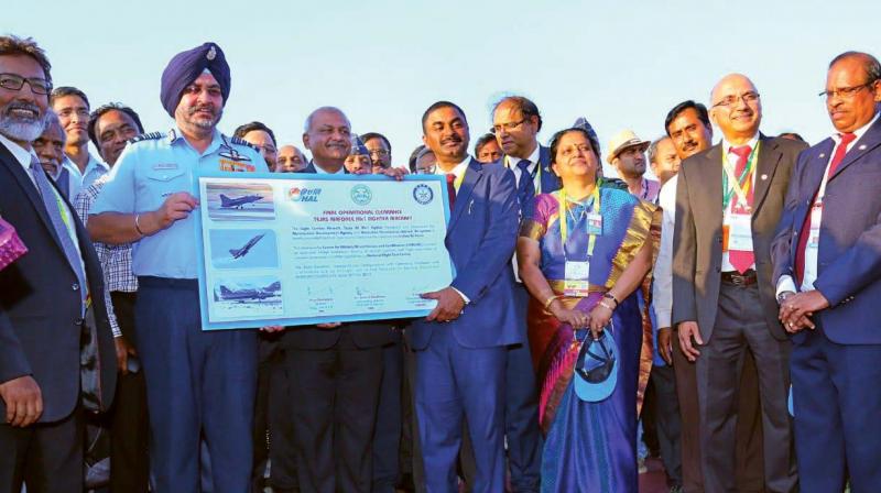 Chief of Air Staff, Air Chief Marshal Birender Singh Dhanoa, receives the  release to service certificate, or the final operational clearance, of Tejas from the Defence Research and Development Organisation at Aero India in Bengaluru on Wednesday.