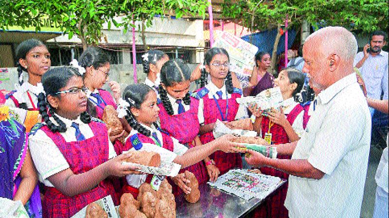 Children of Pollocks School distribute clay Ganesh idols to the people on the eve of Vinayak Chaturthi celebrations in Visakhapatnam on Tuesday. (Photo: DC)