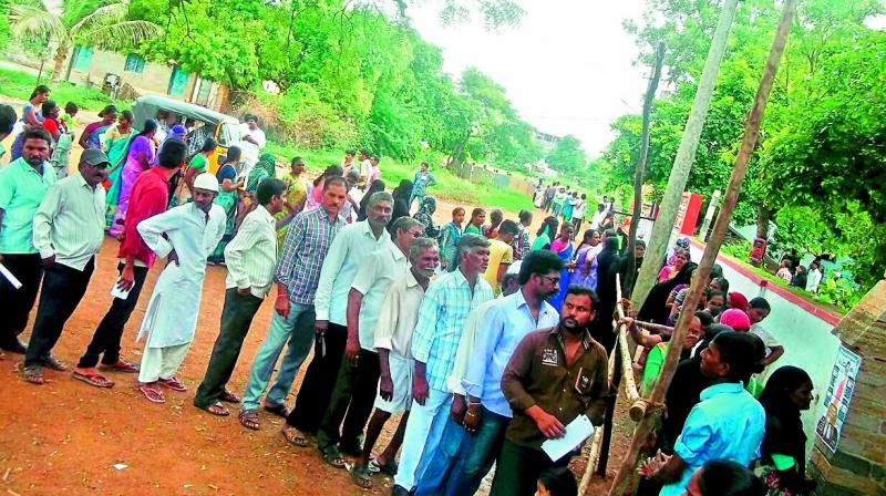 Voters stand in queue to cast their vote at a polling booth in Nandyal on Wednesday. (Photo: DC)