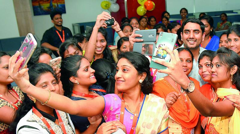 IT Minister Nara Lokesh poses for a selfie with young techies at the inauguration of software companies, Tech Hub - APEITA inside AP Cyber Towers at Tech Mahindra in Visakhapatnam on Thursday. (Photo: DC)