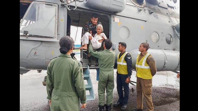 Indian Air Force members conduct rescue and evacuation drive in flood-affected regions of Kerala. (Photo: Indian Navy Twitter via PTI)