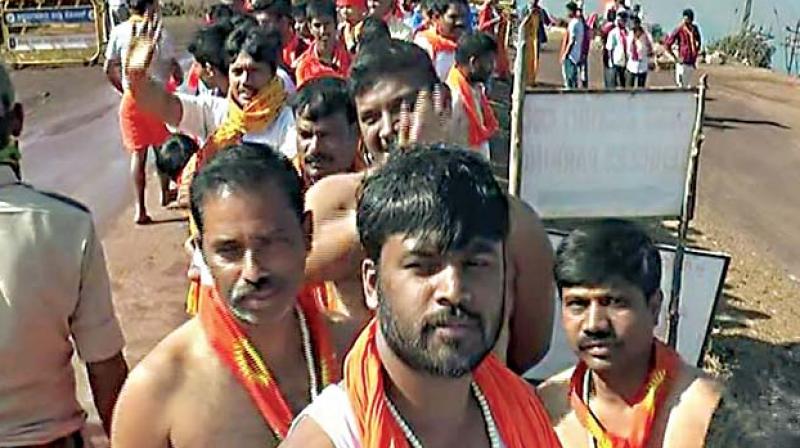 Thousands of devotees stand in queues on the occasion of Datta Jayanti organised by VHP and Bajarang Dal at  Bababudan Giri near Chikkamagaluru on Saturday	KPN