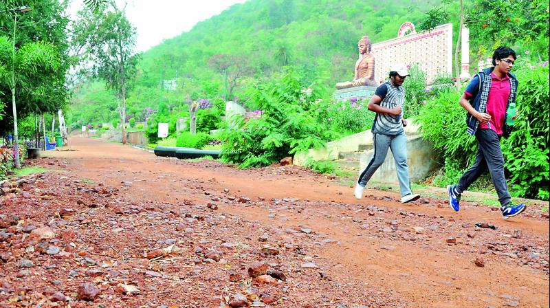Joggers try to negotiate their ways as tracks were not restored properly after the underground cabling works at VUDA Health Arena near Kailasagiri in Visakhapatnam on Monday. (Photo: DC)