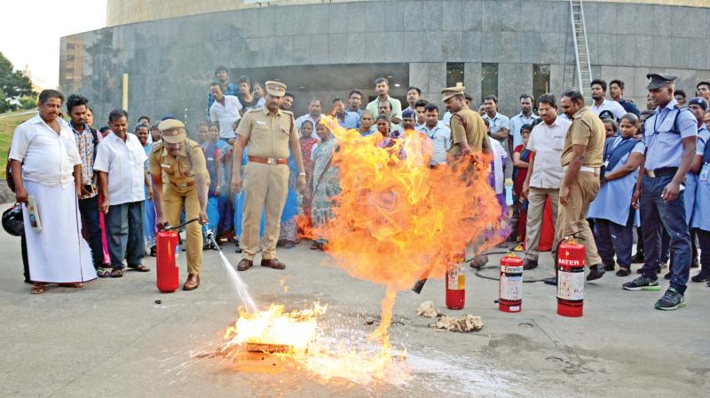 Members of the fire safety department put  forth a demo on how to douse a fire, at the Omandurar super multi-specialty  hospital, in Chennai, on Tuesday. (Photo: DC)