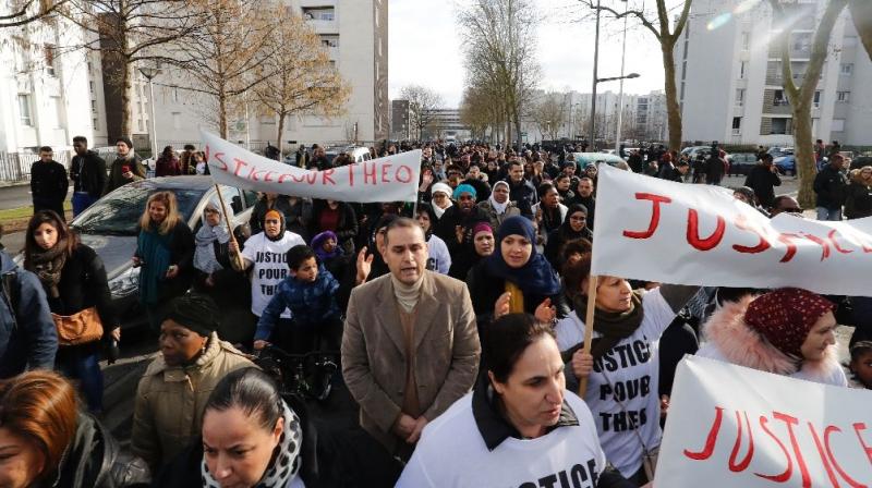 People holding signs reading \Justice for Theo\ march through Aulnay-sous-Bois, north of Paris (Photo: AFP)