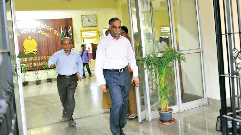 A sullen H.N. Sathyanarayana Rao, who was removed as DGP (prisons), walks out of the prisons department office after handing over charge to N.S. Megharikh in Bengaluru on Tuesday. (Photo: Shashidhar B.)