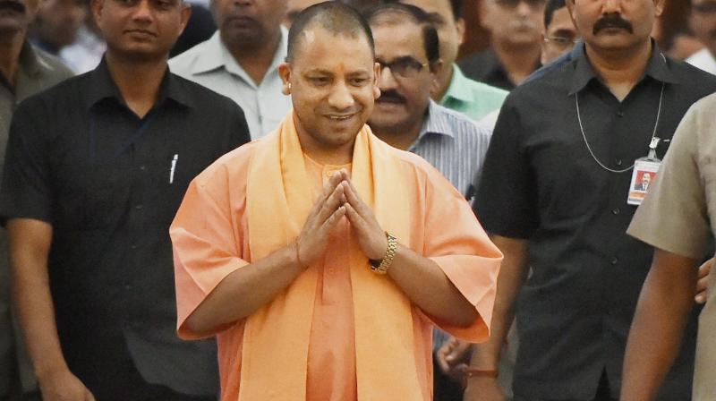 Uttar Pradesh Chief Minister Yogi Aditiyanath walks to attend the Assembly session in Lucknow. (Photo: PTI)