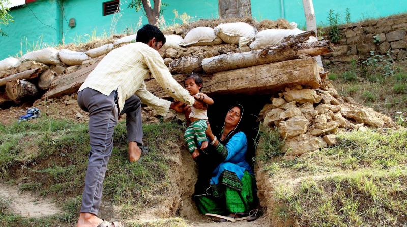 Border migrants take shelter in a bunker after shelling from Pakistan side at Nowshera sector of Rajouri district. (Photo: PTI)
