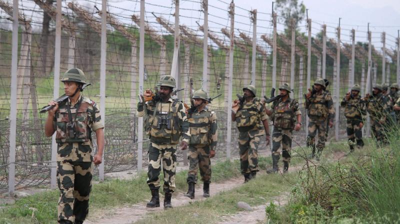 BSF personnel patrolling at the international border on the outskirts of Jammu. (Photo: PTI)