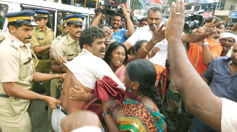 Cops take away members of the Pompilai Orumai, a collective of women employees of Munnar tea gardens who were protesting against the comments of power minister M.M. Mani. (Photo:  DC)