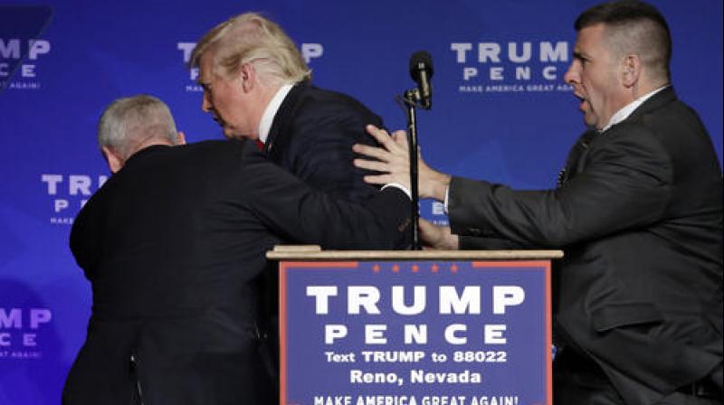 Secret Service agents rush Republican presidential candidate Donald Trump off the stage at a campaign rally in Reno, Nevada. (Photo: AP)