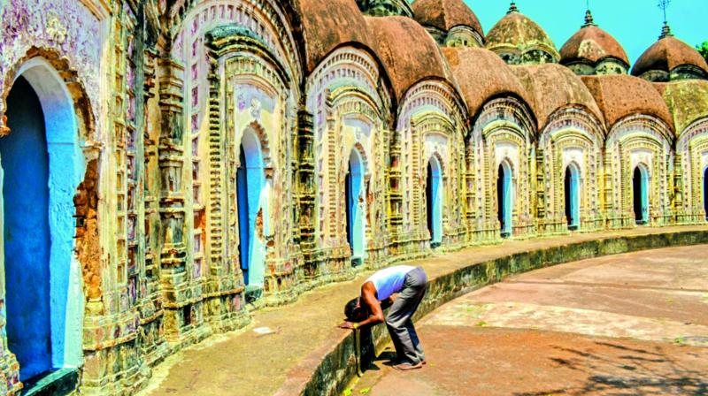 A man bows his head and prays at the Shiva Temples of Burdwan.