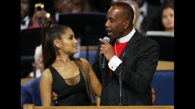 After her performance, Ariana Grande was congratulated by Bishop Charles H Ellis III, who wrapped his arm around her, his hand high above her waist and his fingers pressed against her chest. (Photo: AP)