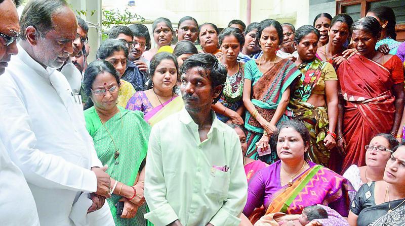 BJP Telangana unit president and Musheerabad MLA K. Laxman listens to the father of deceased infant at Koti maternity hospital in Hyderabad on Saturday (DC)