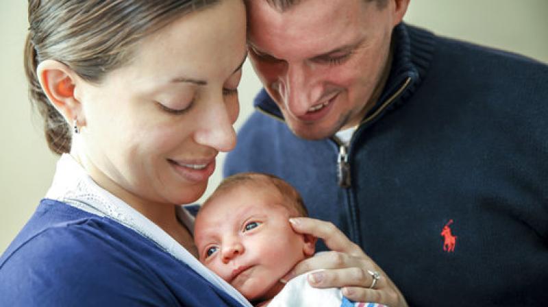 Sarah Murray and her husband, Tom, hold their newborn son, Owen, at Bridgeport Hospital in Bridgeport, Conn.(Photo: AP)