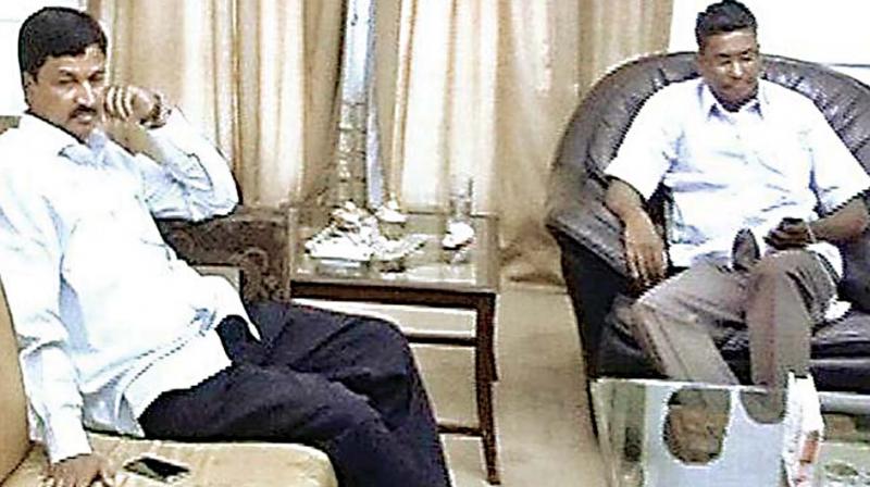 A file photo of Municipal Administration Minister Ramesh Jarkiholi with his brother Satish Jarkiholi