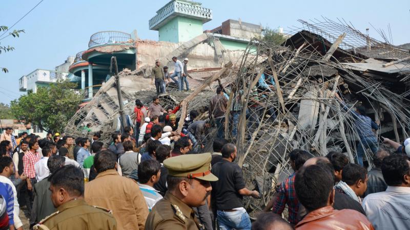 Police carrying out resuce work at the site of the under-construction building which collapsed killing at least seven labourers, in Jajmau in Kanpur. (Photo: PTI)