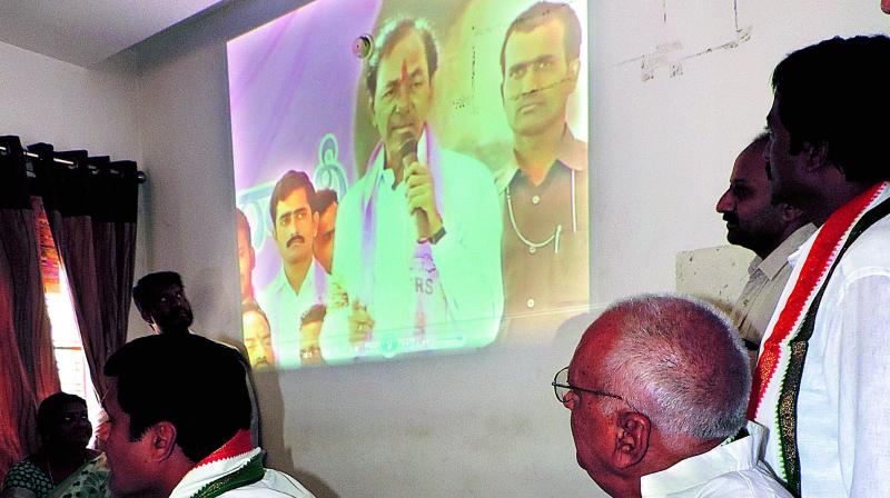Congress leaders play a video clipping of Chief Minister K. Chandrasekhar Raos 2014 speech in Adilabad on Saturday. (Photo: DC)