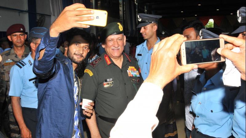A visitor takes a selfie with Army Chief Gen. Bipin Rawat. (Photo: P. Surendra)