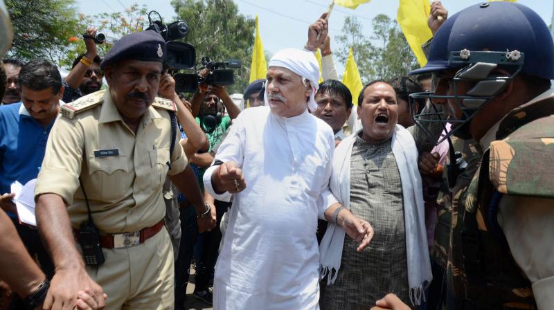Bharatiya Kisan Mazdoor Mahasangh President Shiv Kumar Sharma Kakkaji with farmers being arrested by the police during their Chakkajam protest against Governments anti-farmers policies at Misrod in Bhopal on Friday. (Photo: PTI)