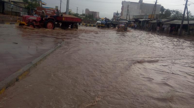 Rain water overflows at Kallur in Kurnool on Saturday. (Photo: DC)