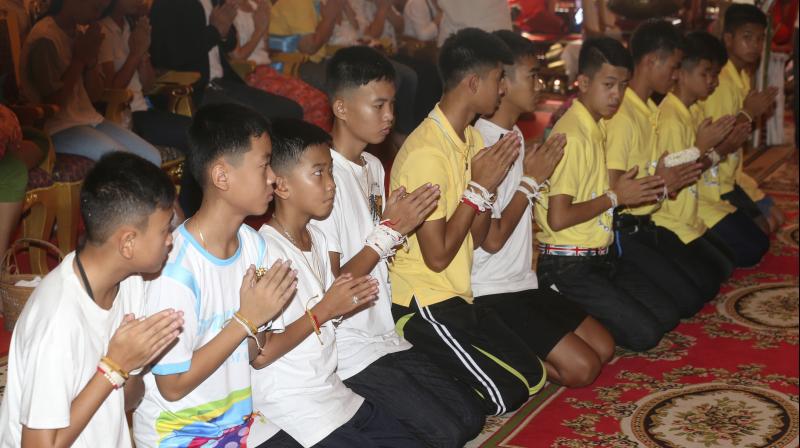 On Thursday, some of the boys and their relatives took part in religious ceremonies at Mae Sais Wat Pha That Doi Wao temple  an ancient temple with scenic views of the surrounding countryside. (Photo: AP)