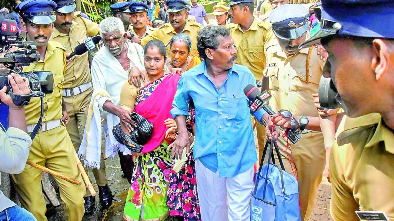 Police escort Madhavi (of Andhra Pradesh) after she was heckled while she was seeking the entry to the Lord Ayyappa Temple at Sabarimala.  (Photo:PTI)