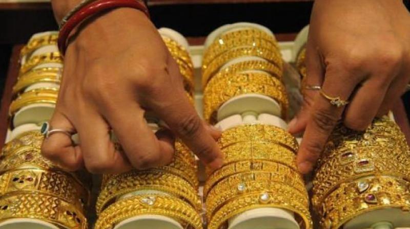 Spot gold was down 0.1 per cent to USD 1,202 per ounce in early trade, after dropping to as much as USD 1,197.31.