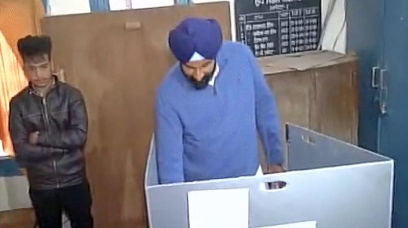 Cabinet minister and Akali candidate Bikram Singh Majithia casting his vote during repolling. (Photo: Twitter/ANI)