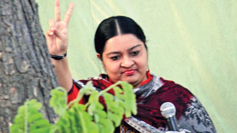 Chief Minister J. Jayalalithaas niece Deepa waves to her supporters.