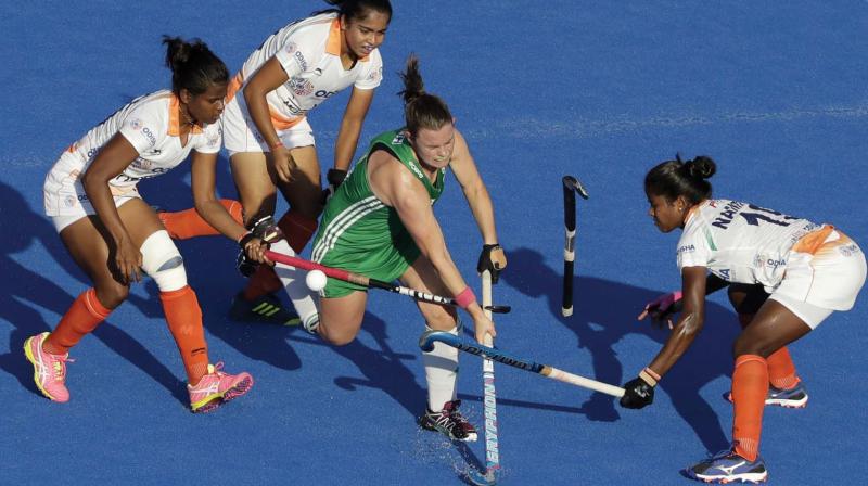 Irelands Lizzie Colvin (centre) vies for the ball with India players in the World Cup quarterfinal on Thursday. (Photo:AP)