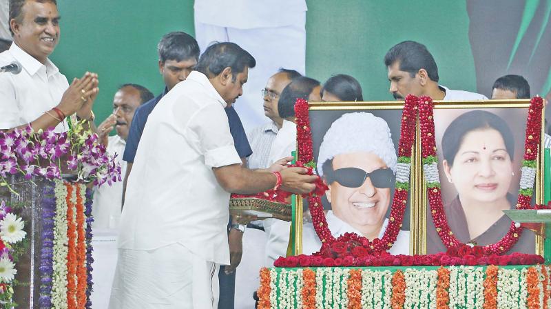 Chief Minister Edappadi K. Palaniswami pays floral tribute to the portrait of former chief minister M.G. Ramachandran on his 100th birthday celebrations at VOC grounds in Coimbatore on Sunday. (Photo: DC)