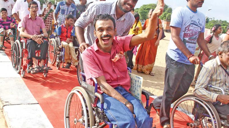 Children with disabilities play at the Marina beach on account of celebrations of International Day of disabled persons on Sunday. Greater Chennai Corporation along with various NGOs laid down ramps till the beachside, installed mobile toilets and resting areas to facilitate people with disabilities to be able to access beaches  at Marina Beach on the occassion. (Photo: DC)