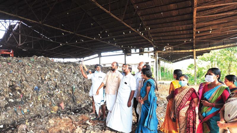 Opposition members in City Corporation council cover their nose at the Brahmapuram plant unable to bear the stench at the site.