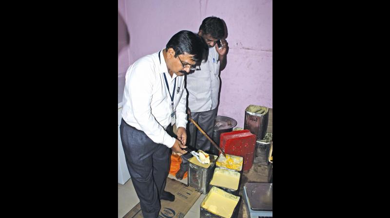 Food safety officers inspect tins of adulterated ghee in Saidapet on Tuesday (Photo: DC)