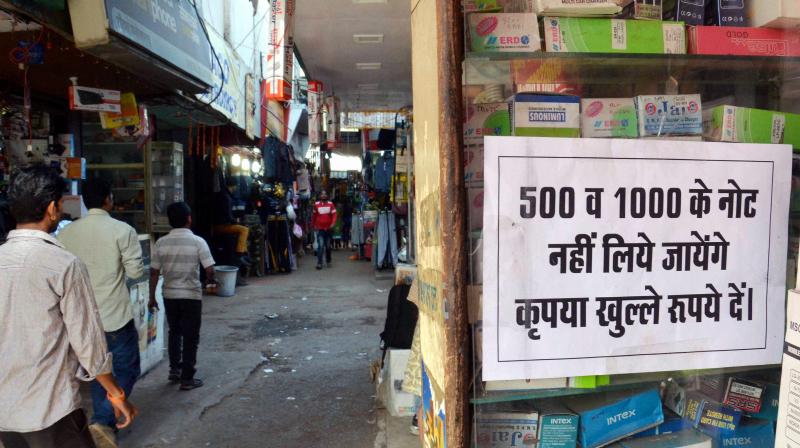 A shopkeeper pasted a notice in his shop denying to accept Rupees 500 and 1000 currency notes against selling of goods, in Bhopal. (Photo: PTI)
