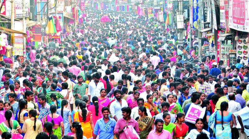 People throng main road to purchase clothes and other items on the eve of Sankranti in Rajahmundry on Saturday, Even people from Samalkota, Ravulapalem, Nidavolu and Kovvuru came for shopping. (Photo: DC)