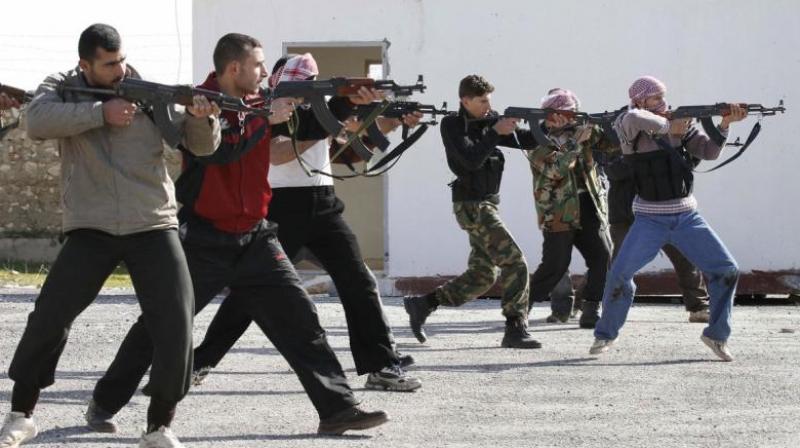 Syrian rebels aim during a weapons training exercise outside Idlib, Syria. (Photo: AP)