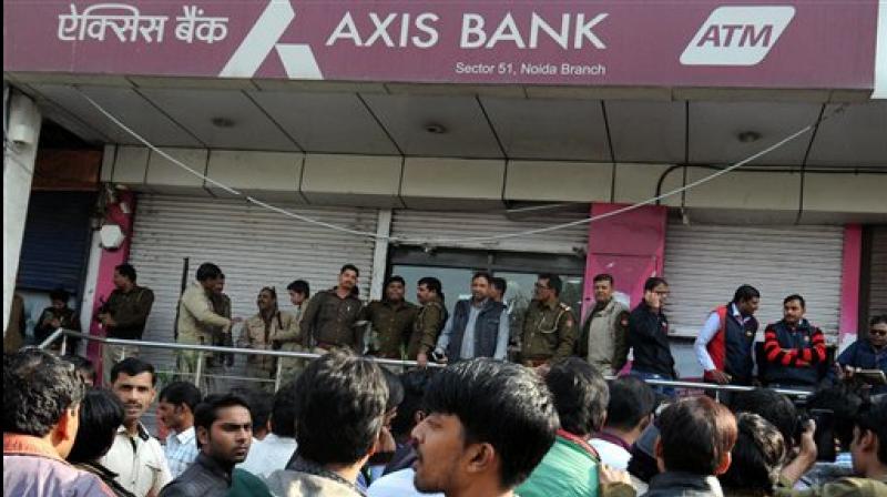 IT officials raid an Axis Bank branch in Noida on Thursday. (Photo: AP)