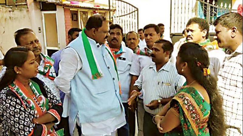 A file photo of former mayor P. Ramesh with people of a locality in CV Raman Nagar