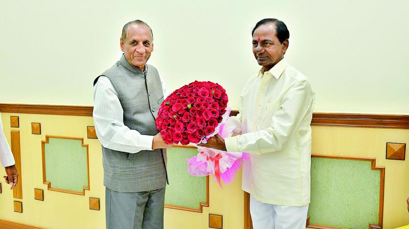 Governor E.S.L. Narasimhan is being greeted by Chief Minister K. Chandrashekhar Rao on the occasion of New Year on Monday. (Photo: DC)