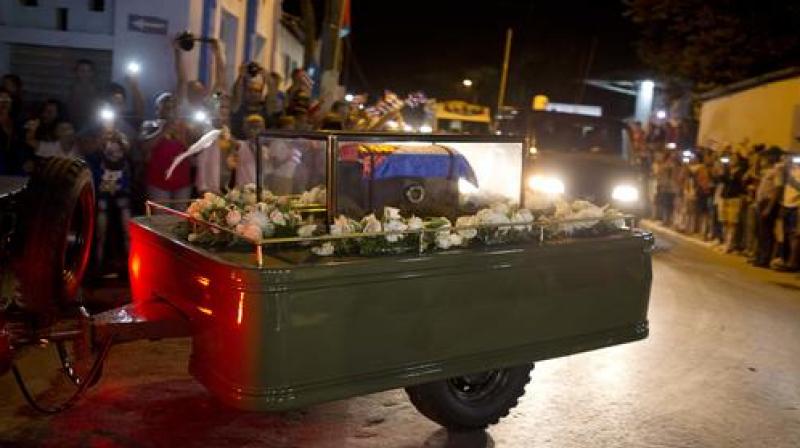 The flag-covered urn, which rested under a glass case on a small olive-green trailer, arrived in Santa Clara after midnight and entered a complex with a mausoleum and museum dedicated to Guevara. (Photo: AP)