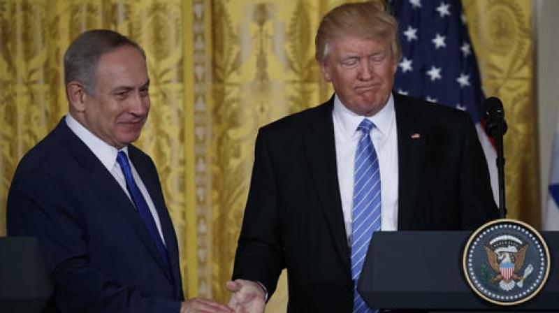 US President Donald Trump shakes hands with Israeli Prime Minister Benjamin Netanyahu during a news conference in the East Room of the White House in Washington. (Photo: AP)