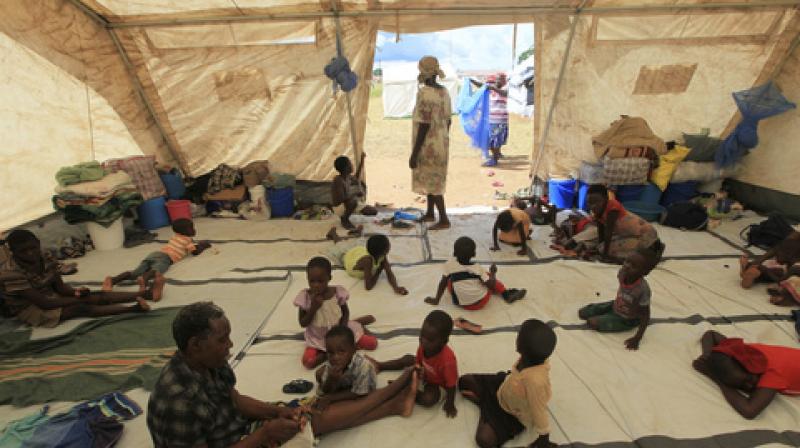 Children sit inside a tent at a camp set up for flood victims in Tsholostho about 200 kilometres north of Bulawayo, Saturday, March 4, 2017. (Photo: AP)