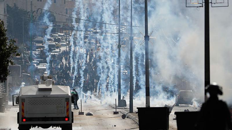 Sporadic clashes broke out between Palestinians and Israeli forces on Thursday, as Israel deployed hundreds more troops to the occupied West Bank amid uncertainty over the fallout. (Photo: AFP)