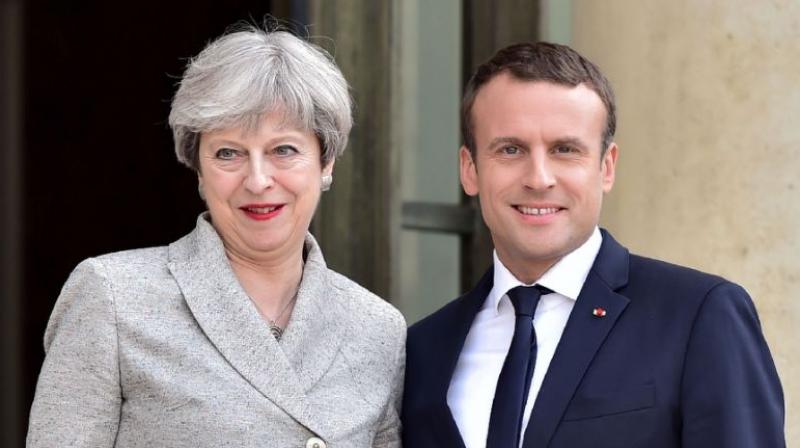 Britains Prime Minister Theresa May (L) is greeted by Frances President Emmanuel Macron ahead of a meeting at The Elysee Palace in Paris (Photo: AFP)